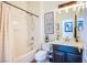 Cozy bathroom featuring a shower-tub combo, framed art, and charming decor at 8029 Flambeau St, Las Vegas, NV 89131