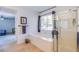 Bright bathroom featuring a separate shower and tub with a window providing natural light at 8029 Flambeau St, Las Vegas, NV 89131