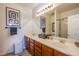 Bathroom with a double sink vanity, framed mirrors, and decorative fixtures at 8029 Flambeau St, Las Vegas, NV 89131