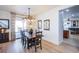 Bright dining room featuring a rustic wood table, decorative lighting, and easy access to the backyard patio at 8029 Flambeau St, Las Vegas, NV 89131