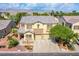 Beautiful two-story home with a stone facade, manicured front yard, and mountain views in the distance at 8029 Flambeau St, Las Vegas, NV 89131