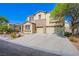 Beautiful two-story home with a stone facade and spacious driveway, set against a clear blue sky at 8029 Flambeau St, Las Vegas, NV 89131
