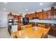 Spacious kitchen boasts cherry cabinets, granite counters, island, and eat-in dining at 8029 Flambeau St, Las Vegas, NV 89131