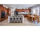 Eat-in kitchen boasts cherry cabinets, granite counters, island, and modern appliances at 8029 Flambeau St, Las Vegas, NV 89131