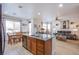 Open-concept kitchen with island, leading to dining area and living room with sofa at 8029 Flambeau St, Las Vegas, NV 89131