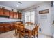 Eat-in kitchen features cherry cabinets, granite counters, and decorative wall hangings at 8029 Flambeau St, Las Vegas, NV 89131