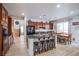 Open-concept kitchen featuring island, dining area, and dark cherry cabinets at 8029 Flambeau St, Las Vegas, NV 89131
