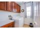 Functional laundry room equipped with modern washer, dryer, and storage cabinets at 8029 Flambeau St, Las Vegas, NV 89131