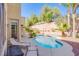 Backyard featuring a sparkling pool, lounge chairs, and desert landscaping at 8029 Flambeau St, Las Vegas, NV 89131