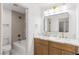 Well-lit bathroom featuring dual sinks, modern fixtures, and a tub with shower at 8032 Deep Stone Ave, Las Vegas, NV 89149