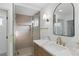 Bathroom showcasing a shower, gold hardware, vanity with marble countertop, and rectangular mirror at 8032 Deep Stone Ave, Las Vegas, NV 89149