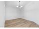 Bright bedroom featuring modern lighting fixture and stylish wood-look flooring at 8032 Deep Stone Ave, Las Vegas, NV 89149
