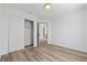 Neutral bedroom featuring modern closet doors, stylish wood-look floors and a view to another room at 8032 Deep Stone Ave, Las Vegas, NV 89149