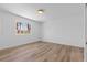 Bright bedroom featuring stylish wood-look floors and a window overlooking an outdoor space at 8032 Deep Stone Ave, Las Vegas, NV 89149