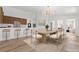 Modern kitchen and dining area featuring a breakfast bar, stainless steel appliances, and stylish lighting at 8032 Deep Stone Ave, Las Vegas, NV 89149