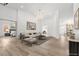 Open-concept living area with hardwood floors, modern lighting, and access to other rooms at 8032 Deep Stone Ave, Las Vegas, NV 89149