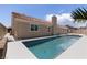 Private backyard with a sparkling pool, spacious patio, and a classic brick chimney, ideal for relaxation at 8032 Deep Stone Ave, Las Vegas, NV 89149