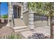 Charming home exterior featuring stone accents, a two-car garage, and inviting front steps at 8121 Russell Creek Ct, Las Vegas, NV 89139