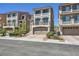 Beautiful townhome with a two-car garage, balcony, and manicured landscaping at 8121 Russell Creek Ct, Las Vegas, NV 89139