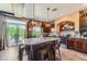 A well-lit kitchen offers a granite-topped island, stainless steel appliances and a view of the outdoors at 8121 Russell Creek Ct, Las Vegas, NV 89139