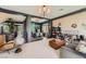 Spacious living room with modern furnishings, neutral colors, and seamless flow into the dining area at 8121 Russell Creek Ct, Las Vegas, NV 89139