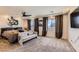 Spacious main bedroom featuring a ceiling fan, sitting area, and neutral decor at 8121 Russell Creek Ct, Las Vegas, NV 89139
