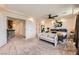 Bright main bedroom featuring a tray ceiling, ceiling fan, and neutral colored carpet at 8121 Russell Creek Ct, Las Vegas, NV 89139