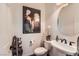 Stylish powder room featuring elegant fixtures, a modern sink, and tasteful decor at 8121 Russell Creek Ct, Las Vegas, NV 89139