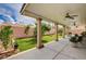 Covered back patio with ceiling fans overlooks the landscaped backyard at 8223 Saddleback Ledge Ave, Las Vegas, NV 89147