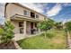 Exterior home view showcasing backyard with patio and lush green lawn at 8223 Saddleback Ledge Ave, Las Vegas, NV 89147