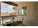 A peaceful outdoor balcony with a table and chairs, offering a scenic neighborhood view at 8223 Saddleback Ledge Ave, Las Vegas, NV 89147
