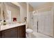 Bathroom featuring a sink, vanity, toilet, and glass-enclosed shower, all with neutral-toned walls at 8223 Saddleback Ledge Ave, Las Vegas, NV 89147
