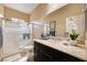 Bright bathroom featuring a walk-in shower, decorative mirror and countertop with modern vessel sink at 8223 Saddleback Ledge Ave, Las Vegas, NV 89147
