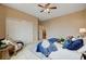 Cozy bedroom featuring a king size bed with blue comforter, chair, and lots of natural light at 8223 Saddleback Ledge Ave, Las Vegas, NV 89147