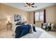 Bright bedroom featuring a king size bed with blue comforter, decor, and lots of natural light at 8223 Saddleback Ledge Ave, Las Vegas, NV 89147
