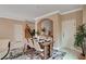 Chic dining area with a modern table set, stylish decor, and an adjacent staircase at 8223 Saddleback Ledge Ave, Las Vegas, NV 89147