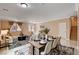 Open dining area with a modern table set, tile floors, and connection to living room at 8223 Saddleback Ledge Ave, Las Vegas, NV 89147
