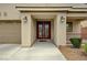 Inviting home entrance with double doors, manicured shrubbery and covered porch at 8223 Saddleback Ledge Ave, Las Vegas, NV 89147