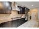 A kitchen with a stainless steel range hood, granite countertops, mosaic backsplash, and stainless steel appliances at 8223 Saddleback Ledge Ave, Las Vegas, NV 89147