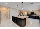 A kitchen with a large center island, stainless steel appliances, and an open concept to the living room at 8223 Saddleback Ledge Ave, Las Vegas, NV 89147