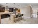 Well-lit kitchen with dark cabinets, granite countertops, stainless steel appliances, and an island with bar seating at 8223 Saddleback Ledge Ave, Las Vegas, NV 89147