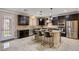 Modern kitchen boasting stainless steel appliances, granite countertops, a tile backsplash, and an island with seating at 8223 Saddleback Ledge Ave, Las Vegas, NV 89147