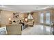 Open-concept living room with elegant decor, tile floors, and a view of the front door at 8223 Saddleback Ledge Ave, Las Vegas, NV 89147