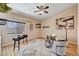 Cozy living room with ceiling fan, stylish decor, natural light, and a comfortable seating arrangement at 8223 Saddleback Ledge Ave, Las Vegas, NV 89147