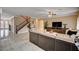 Large living room with tile floors, a staircase, comfortable seating, and neutral decor at 8223 Saddleback Ledge Ave, Las Vegas, NV 89147