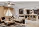 Open-concept living room connected to the kitchen featuring dark cabinetry and a large island with bar seating at 8223 Saddleback Ledge Ave, Las Vegas, NV 89147