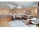 Bright living room with a high ceiling, a plush sectional sofa, and elegant chandeliers at 8223 Saddleback Ledge Ave, Las Vegas, NV 89147