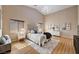 Elegant primary bedroom with hardwood floors, tray ceiling, and large windows for ample natural light at 8223 Saddleback Ledge Ave, Las Vegas, NV 89147