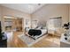 Serene primary bedroom boasting hardwood floors, high ceilings, natural light, and seamless transition to the living area at 8223 Saddleback Ledge Ave, Las Vegas, NV 89147