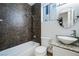 Bathroom featuring a tub-shower combo, granite countertop with vessel sink, and tiled walls at 827 Happy Sparrow Ave, Henderson, NV 89052